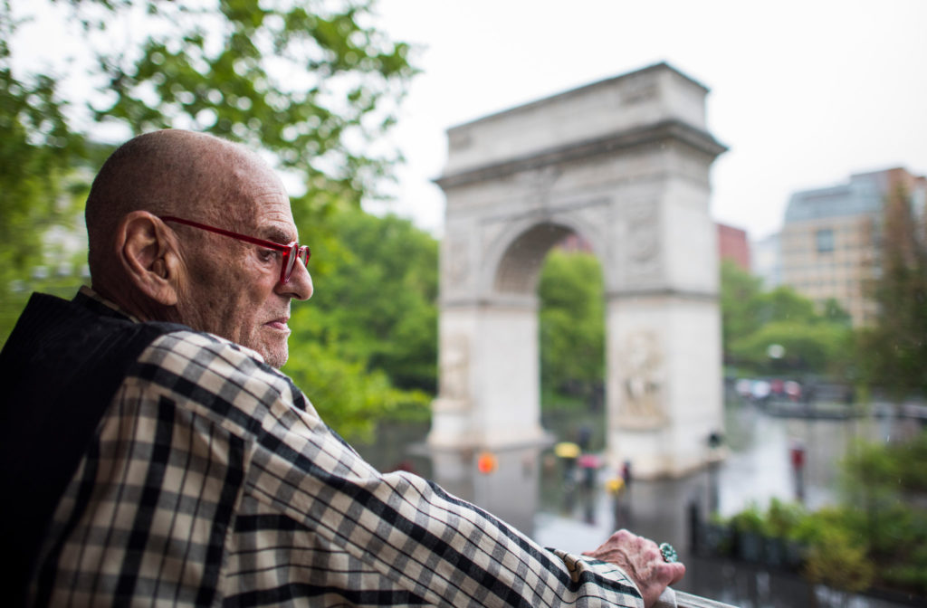 Looking out onto Washington Square Park from the balcony of his apartment on Fifth Avenue. Credit Joshua Bright for The New York Times