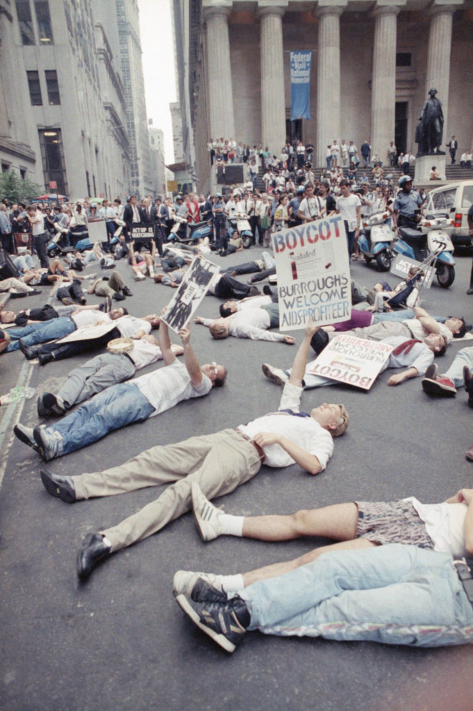 A 1989 protest in front of the New York Stock Exchange organized by Act Up, a group Mr. Kramer founded, against the high cost of the HIV treatment drug AZT. Credit Tim Clary/Associated Press