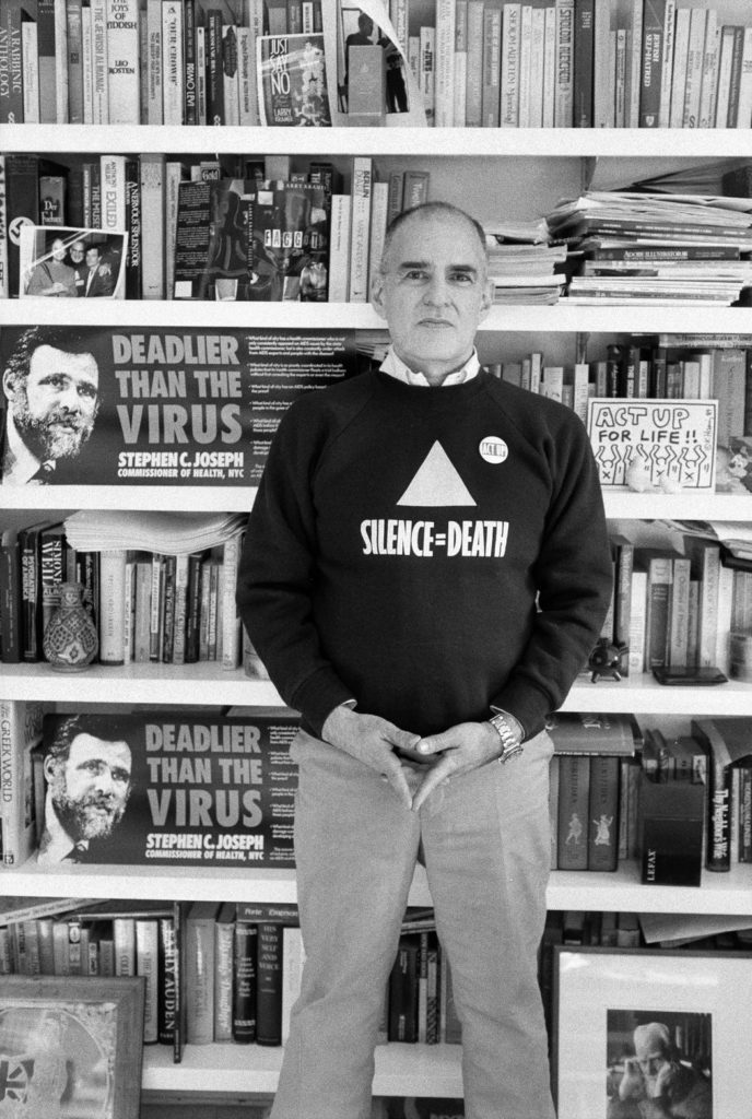 At home in 1989. The graphic on his sweater appeared on posters that activists plastered around New York City in 1987. Credit Sara Krulwich/The New York Times